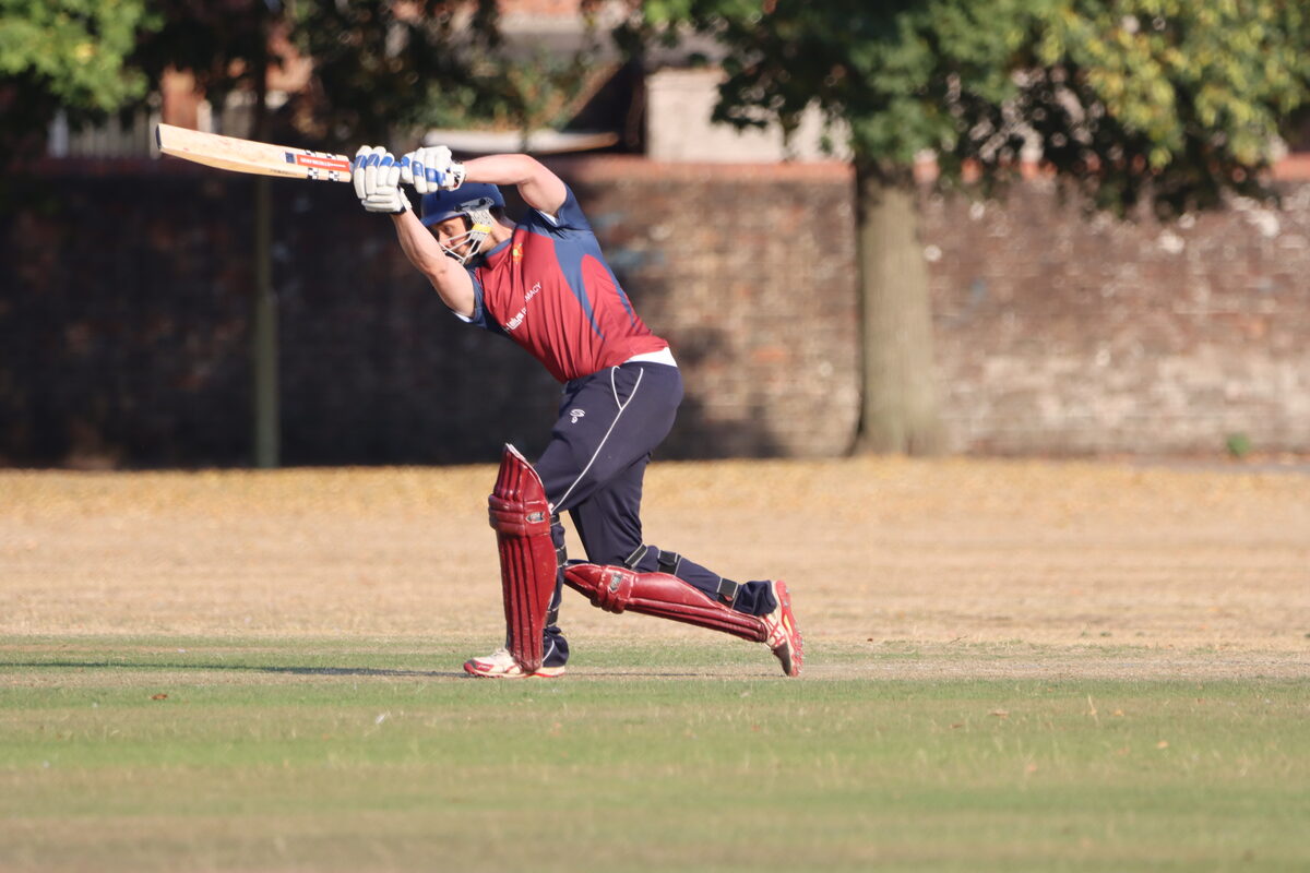 Batsman driving through the covers